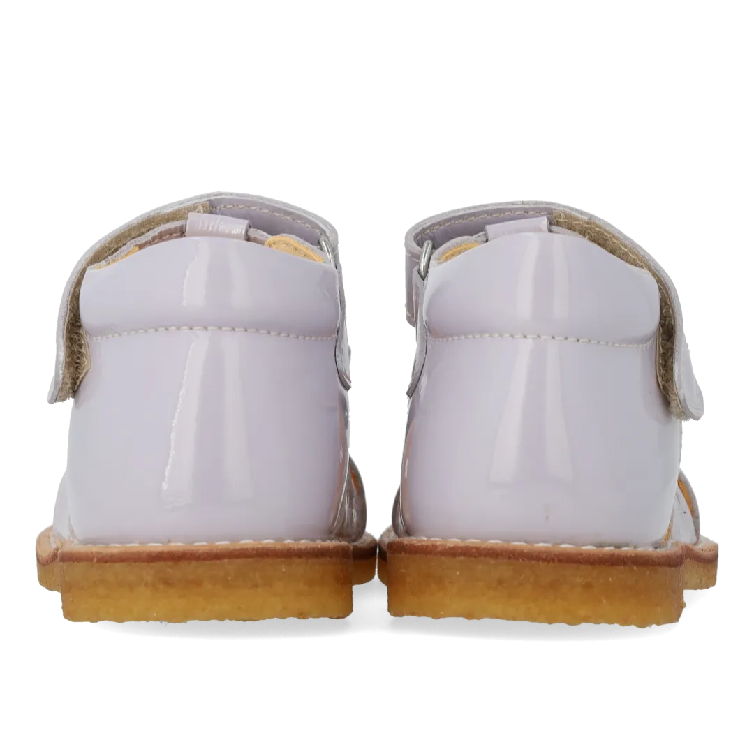 Starter sandal with a bow and velcro closure