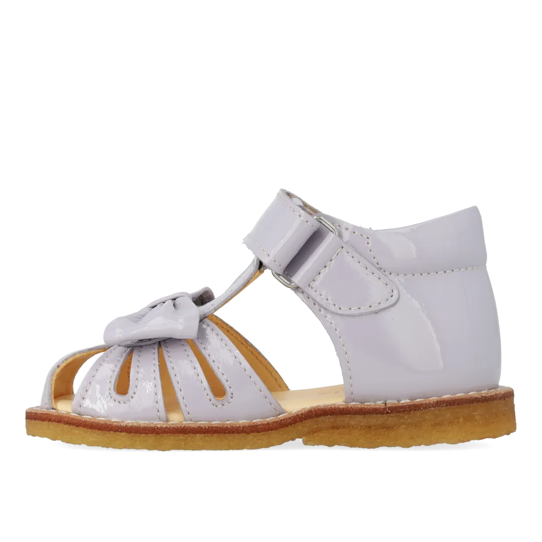 Starter sandal with a bow and velcro closure