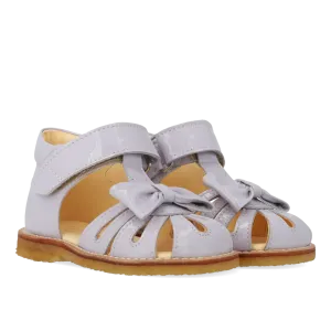 Starter sandal with a bow and velcro closure