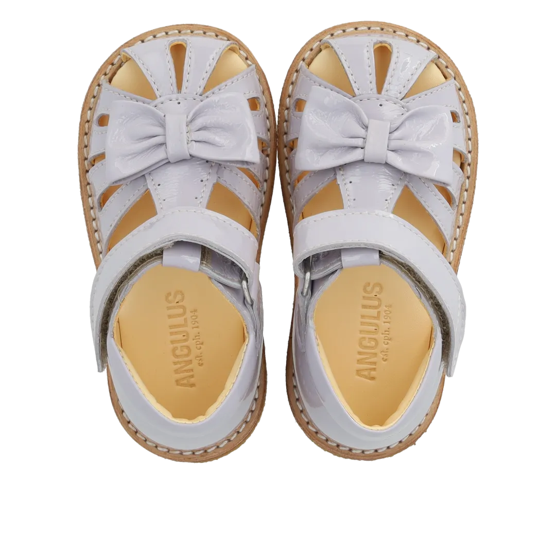 Starter sandal with a bow and velcro closure