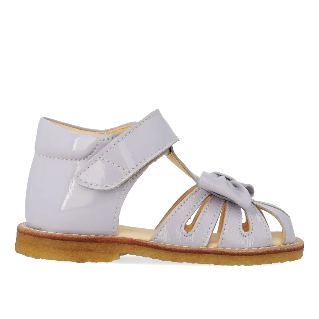 Starter sandal with a bow and velcro closure