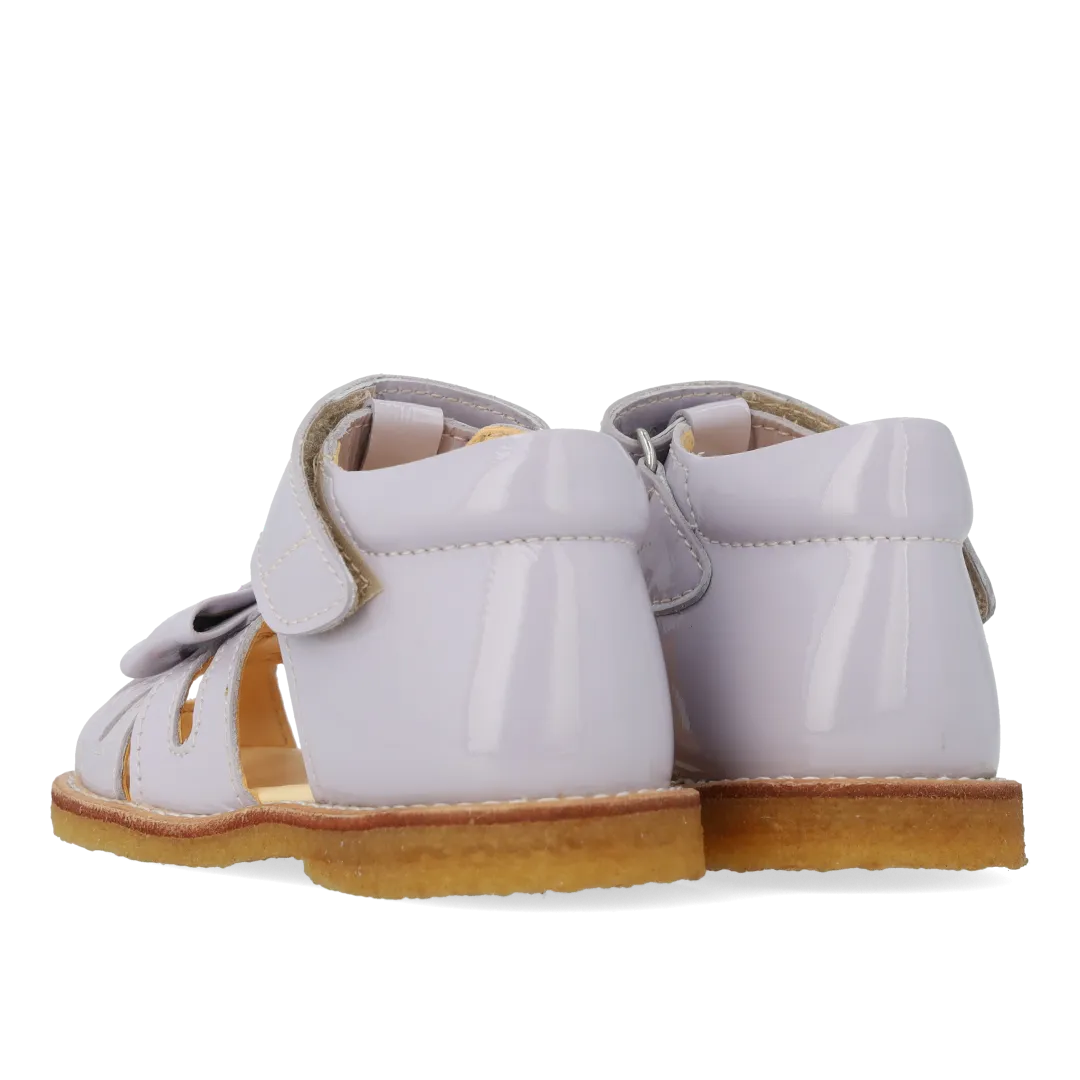 Starter sandal with a bow and velcro closure